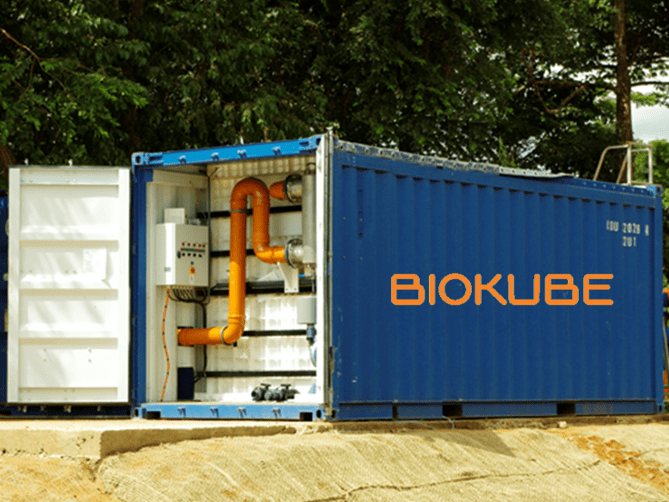 Blue 20-foot BioKube BioContainer with doors open showing orange aeration pipework, deployed at an outdoor site
