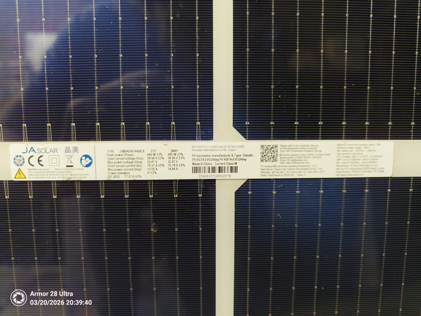 Close-up of solar panel cells with ja solar specification label strip.